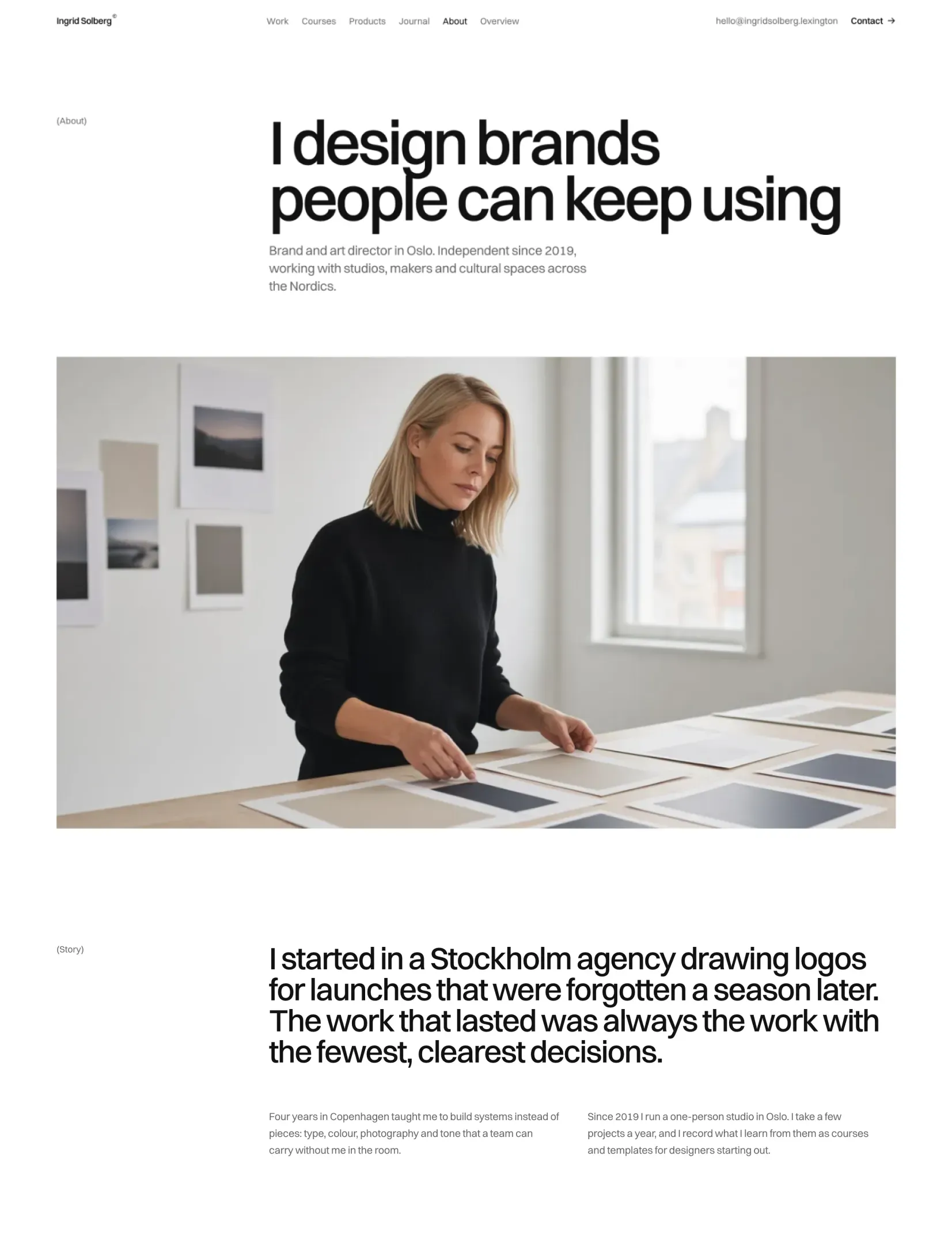 Ingrid Solberg's about page with a photograph of her laying out prints at her desk